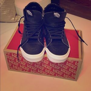 Black and white high top Vans